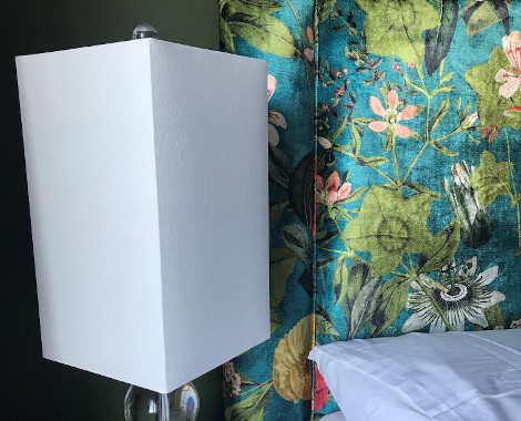 Bedside lamp and bespoke headboard detail of bedroom design