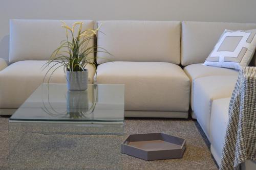 Cream corner sofa, glass coffee table
