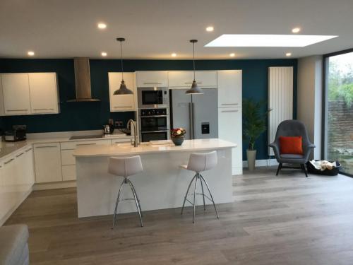 Kitchen extension- white contemporary and pop of orange