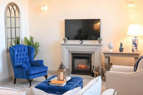 Finline Queen Anne with royal blue velvet deep buttoned ottoman and arch mirror