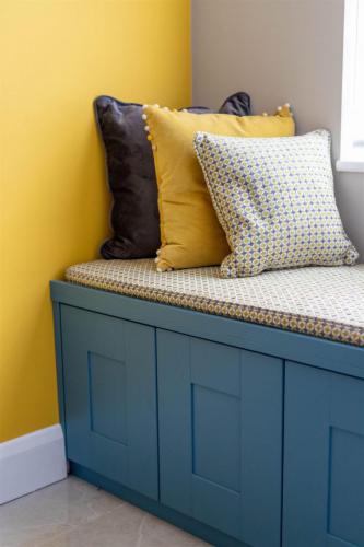 Home office design with window seat  storage underneath. Bench cushion and scatters