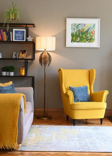 Living area design with sea bright sunny rug, denim scatters and shelving unit
