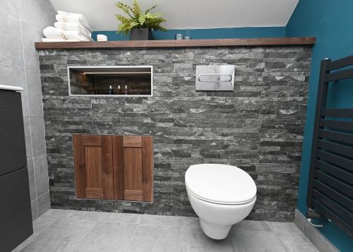 stone tile feature in attic bathroom