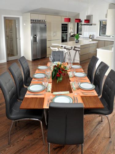 Dining area design using walnut table/grey leather chairs