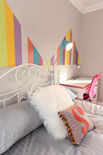 Childs bedroom design with rainbow wall colour pattern